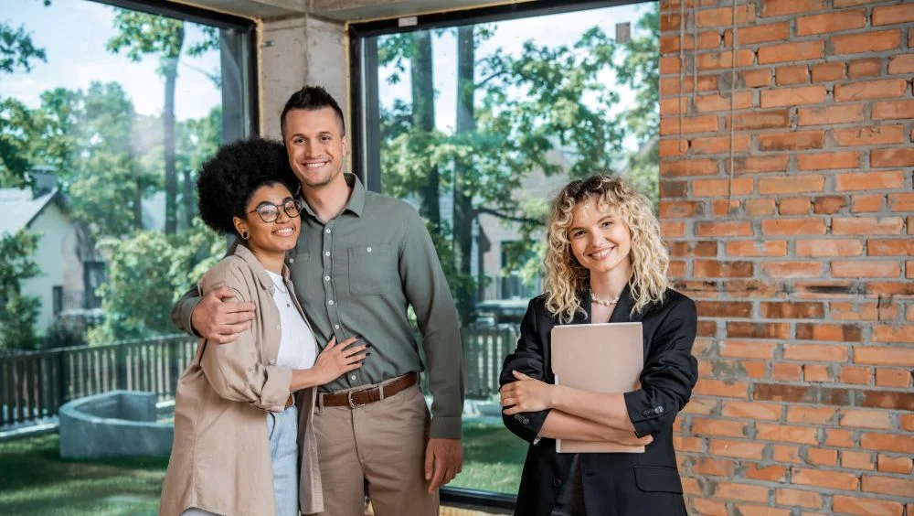 Couple and property manager smiling together